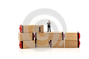 Miniature people : Businessman stand on number 1, 2 and 3 wooden