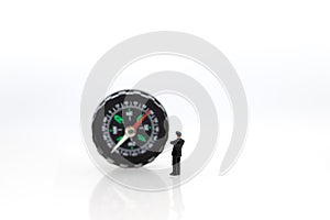 Miniature people : businessman standing with compass. Image use for business concept
