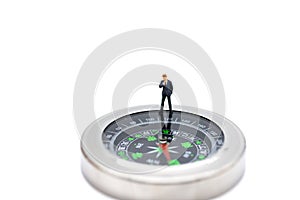 Miniature people : businessman standing with compass. Image use for business concept