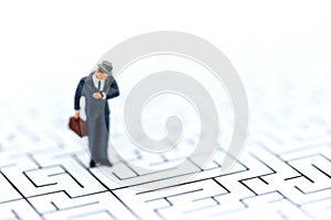 Miniature people : businessman standing on maze,Concepts of fi
