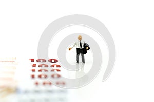 Miniature people : Businessman standing with money,financial con