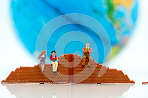 Miniature people: Businessman standing with wall and world. Concepts of finding a solution, problem solving and challenge