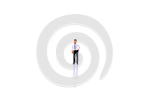 Miniature people : businessman standing on white background.