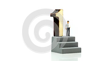 Miniature people : Businessman standing with wooden number of 1,to be the first,Business competition Concept.