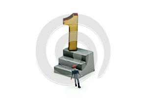 Miniature people : Businessman standing with wooden number of 1,to be the first,Business competition Concept.