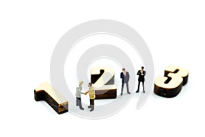 Miniature people : Businessman and team with wooden number of 1,2,3 , to be the first,business competition concept.