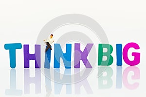 Miniature people: Businessman with text THINK BIG. Image use for idea,, business concept.