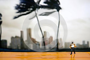 Miniature people : businessman and Tie blowing in wind stand wi