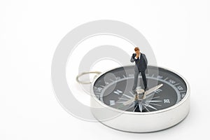Miniature people businessmen analyze standing on compass as background strategy concept and Business concept with copy space and w