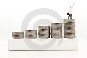 Miniature people : Businessmen standing on a coin stacked increase up respectively, used as a business concept photo