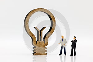Miniature people: Businessmen standing with lamp idea symbol, Concept of Finance, investment and growth in business