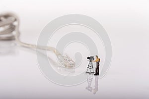 Miniature people camera man with cable cord