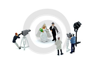 Miniature people : cameraman ,Videographer at work shooting on