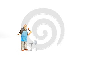 Miniature people ,Chef cooking steak on barbecue grill