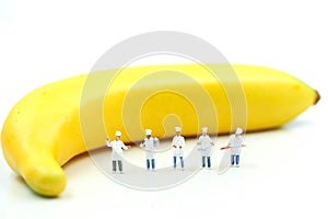 Miniature people : Chef during cooking and working with banana.