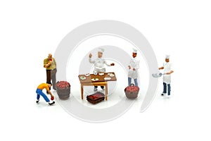 Miniature people : chef and people buying fruits and vegetables