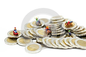 Miniature people : Child having fun to play slider on coins.