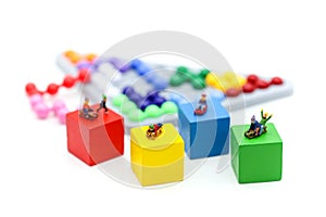 Miniature people: child having fun to play slider on colorful