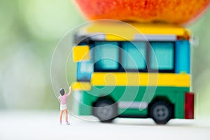 Miniature people : Children going to school by school bus in the first time