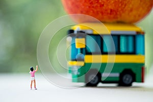 Miniature people : Children going to school by school bus in the first time