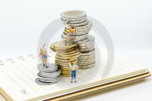 Miniature people: Climbers are climbing coins. Image use for moving forward to success, business concept