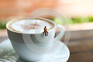 Miniature people : Coffee cup with businessman , image use for charge your energy in the morning