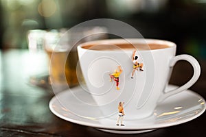 Miniature people : Coffee cup , image use for charge your energy in the morning photo
