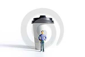 Miniature People and Coffee to-go Cup on white background. Cafe menu concept. Shallow depth of field