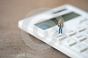 Miniature people Construction worker Keypad TAX button For tax calculation. Easy to calculate. on White calculator on white
