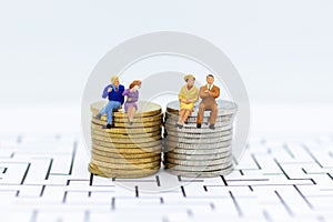 Miniature people: Couple with stack of coins . Image use for background retirement planning, Life insurance concept