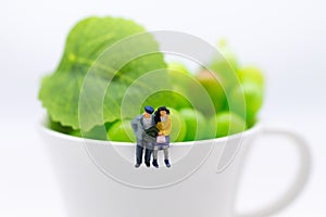 Miniature people: Couples take time for cup of coffee. Image use for food business concept