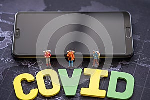 Miniature people: Covic , group backpacker on smartohone