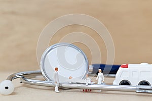 Miniature people : Doctor with nurse carry the patient on a stretcher