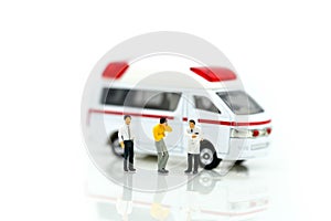 Miniature people : Doctor and Paramedic attending to patient in