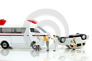 Miniature people : Doctor and Paramedic attending to patient in