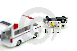 Miniature people : Doctor and Paramedic attending to patient in