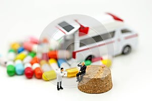 Miniature people : Doctor and Paramedic attending to patient in