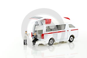 Miniature people : Doctor and Paramedic attending to patient in ambulance,Medicine ambulance concept