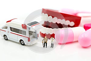 Miniature people : Doctor and Paramedic attending to patient in ambulance,Medicine ambulance concept