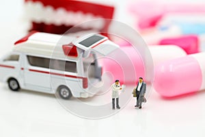 Miniature people : Doctor and Paramedic attending to patient in ambulance,Medicine ambulance concept