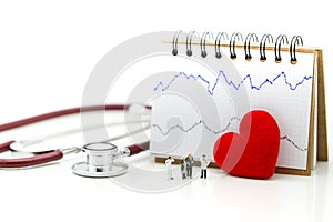Miniature people : Doctor and patient Cardiogram with stethoscope and red heart,A heart beats graph concept.