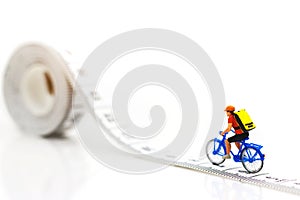 Miniature people enjoy riding a bicycle. Cycling for health Concept
