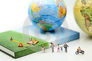 Miniature people : Family and children in park using for concept photo