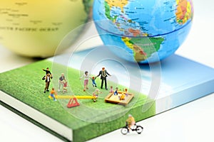 Miniature people : Family and children in park using for concept photo