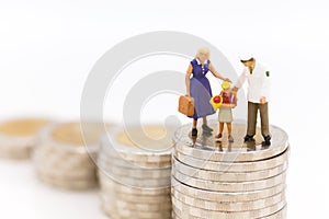 Miniature people, Family figure standing on top of stack coins . Image use for Life insurance concept