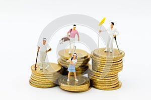 Miniature people: Golfers standing on coins. Image use for . Image use for sport,activities , hobbies concept