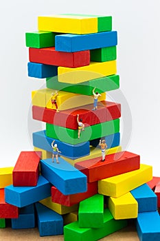 Miniature people : Group Athletes climb on color block wooden. Image use for Activities, travel, business concept