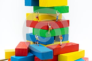 Miniature people : Group Athletes climb on color block wooden. Image use for Activities, travel, business concept