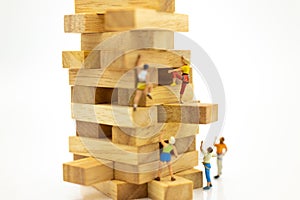 Miniature people : Group Athletes climb on wooden block wooden. Image use for Activities, travel, business concept