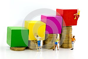 Miniature people : Group Athletes use stairs to climb colorful wood building. Image use for Activities, travel, business concept